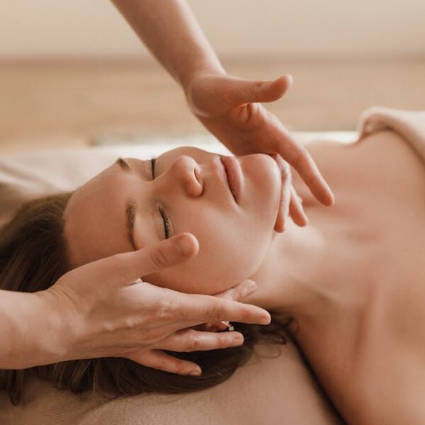 Woman receiving a soothing facial massage, promoting relaxation and wellness.